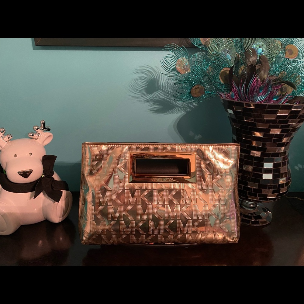 Michael Kors clutch shiny gold with MK signature insignia.